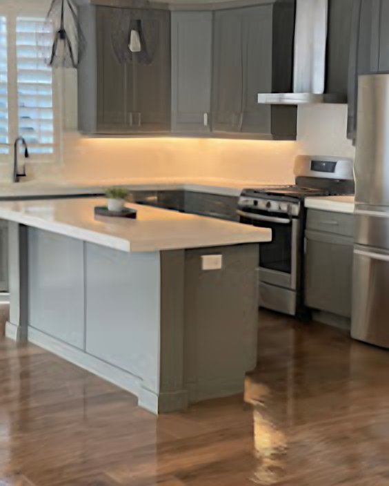 Clean kitchen with a gray island and hardwood floor