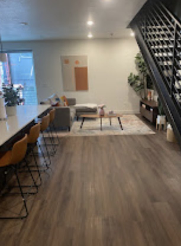 Clean open living area with a staircase and dining table