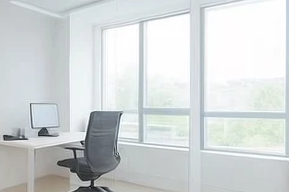Bright, clean office with a desk and large windows